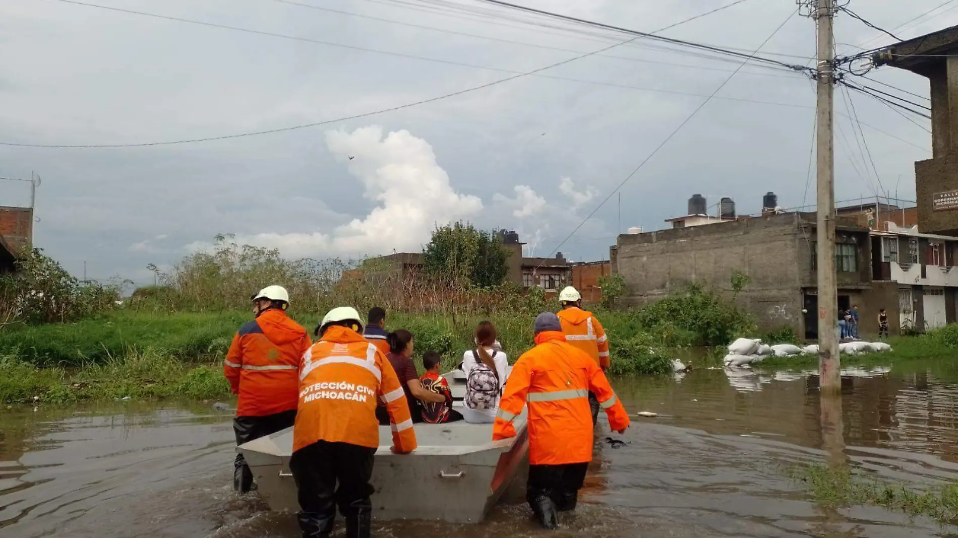 Familia en una lancha por inundaciones